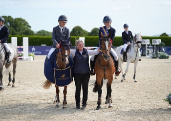 Alfie Diaper and Katie Bradburne share the spoils in the STX Pony Foxhunter Second Round at Coombelands Equestrian